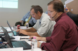 Jeff Kaisand, Iowa Department of Agriculture assistant state veterinarian, and Christopher Kocmoud, Texas Center for Applied Technology senior systems engineer work through the first vignette of the AgConnect® Emergency Exercise.